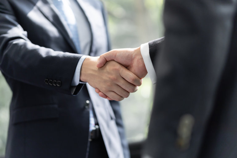 client and business litigation attorney shaking hands