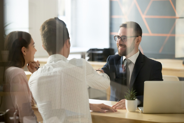 Real estate agent shaking hands with client - how wire transfer fraud happens in real estate