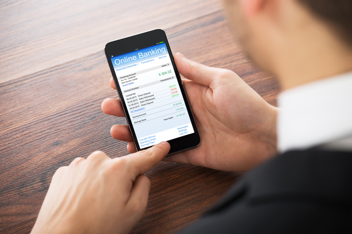 Person using a mobile banking application - what is wire fraud conspiracy?